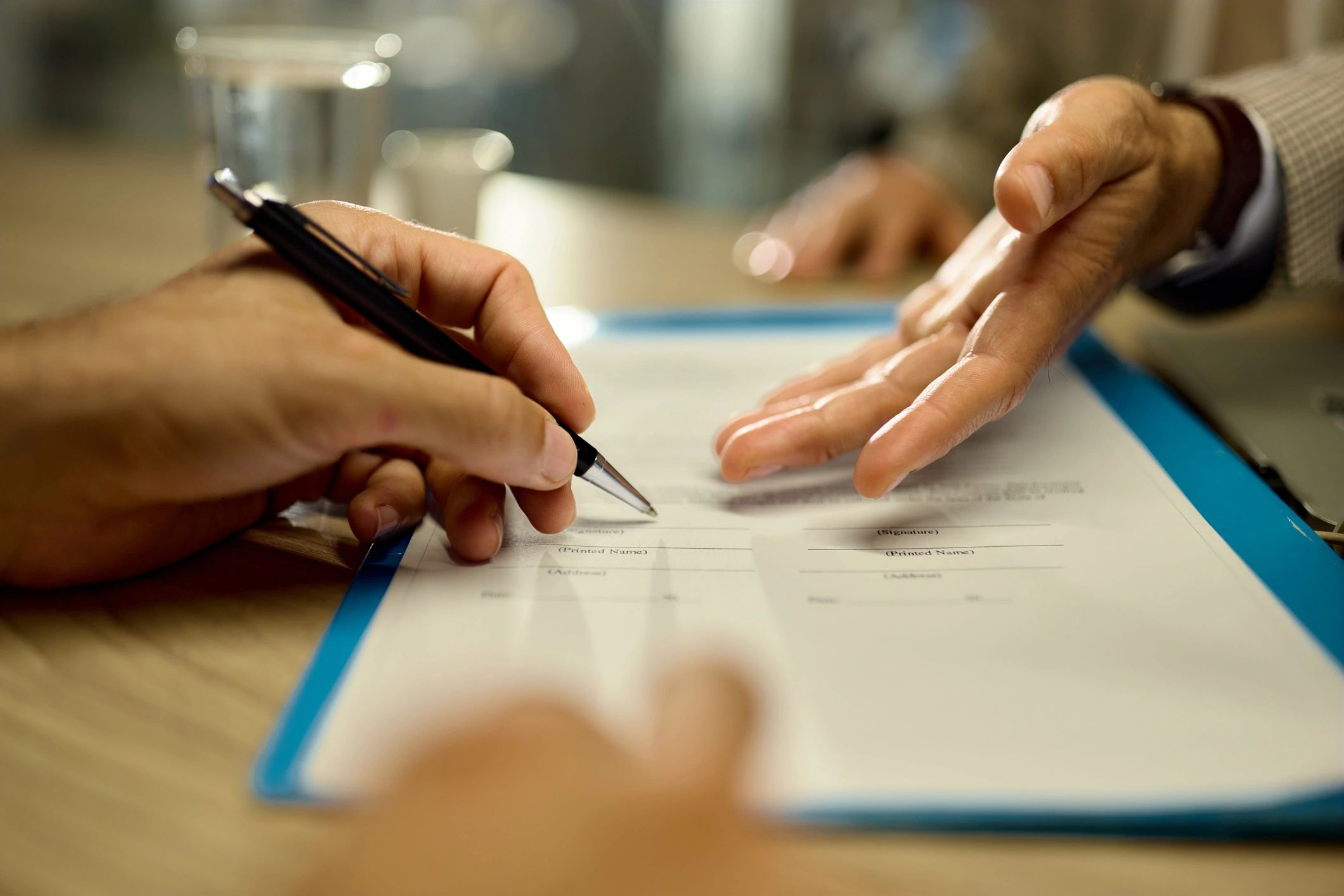 Client signing documents during an insurance consultation